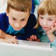 Kids reading computer screen